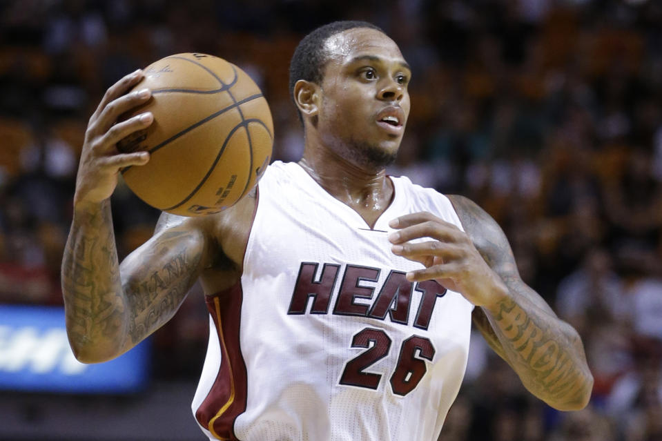 FILE - Miami Heat guard Shannon Brown looks for an open teammate during the second half of a preseason NBA basketball game against the Atlanta Hawks in Miami, in this Tuesday, Oct. 14, 2014, file photo. Eighteen former NBA players, including Brown, have been indicted on charges alleging they defrauded the league's health and welfare benefit plan out of about $4 million, according to an indictment Thursday, Oct. 7, 2021. (AP Photo/Wilfredo Lee, File)