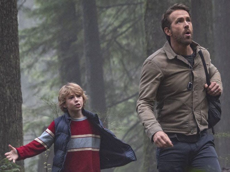 Walker Scobell in a vest, Ryan Reynolds in a cream jacket