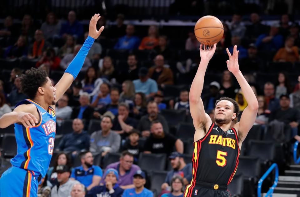 Atlanta Hawks forward Kevin Knox II attempts a 3-point basket as Oklahoma City Thunder guard Aaron Wiggins defends March 30, 2022 in Oklahoma City, Oklahoma.