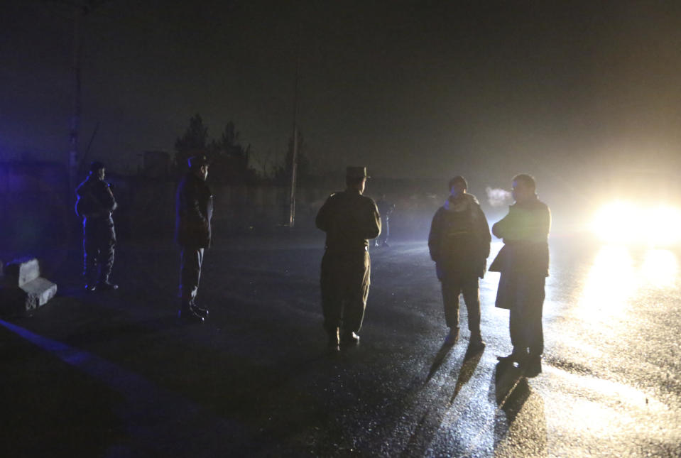 Security forces block a road at the site of a suicide bomb attack in Kabul, Afghanistan, Wednesday, Nov. 28, 2018. Najib Danish, spokesman for Afghanistan's Interior Ministry, said the attack in Kabul took place when a suicide bomber detonated his explosives and then other insurgents started a gun battle with forces in the area. (AP Photo/Rahmat Gul)