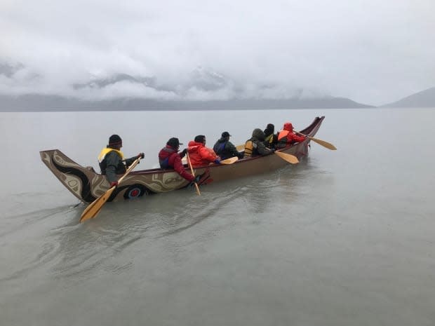Paddlers on a misty day on the Taku River. The boat followed the same route taken by Tlingit for hundreds of years.  (Mike Rudyk/CBC - image credit)