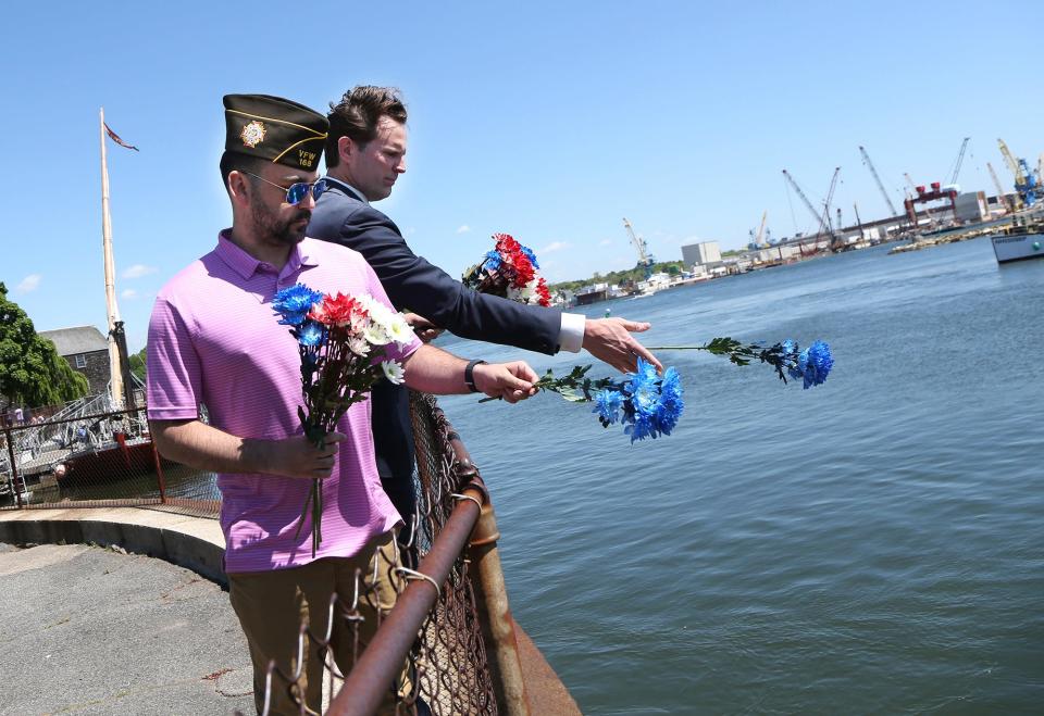 Portsmouth Mayor Deaglan McEachern and Jonathan Day, junior vice commander of VFW Post 168, toss flowers into the Piscataqua River as part of the Burial at Sea ceremony Friday, May 24, 2024.