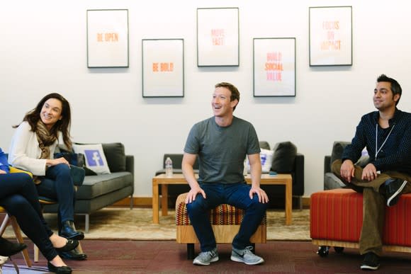 Mark Zuckerberg sitting and smiling.