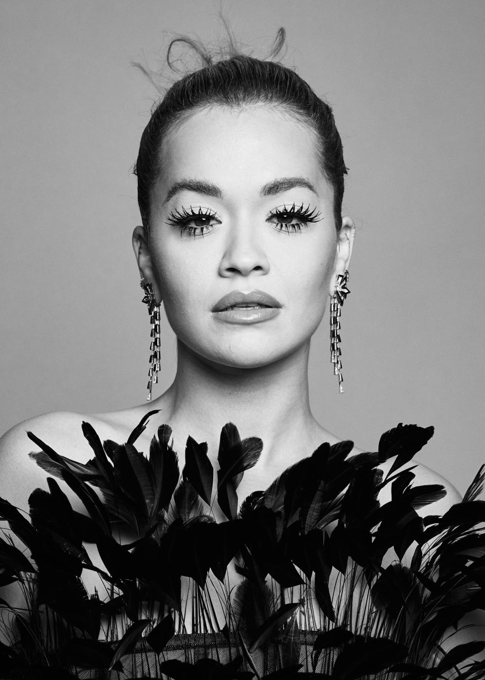 Rita Ora poses in a black feathered bodice and long earrings with her hair tied back during a portrait session at the MTV EMAs 2021 at the Papp Laszlo Budapest Sports Arena on November 14, 2021 in Budapest, Hungary