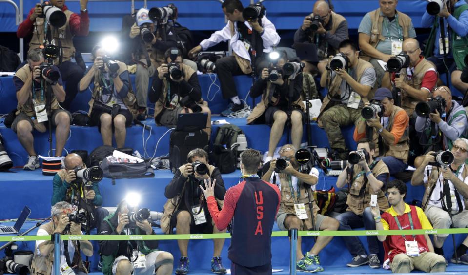 Michael Phelps shows off his fourth gold medal of the Rio Games. (AP)