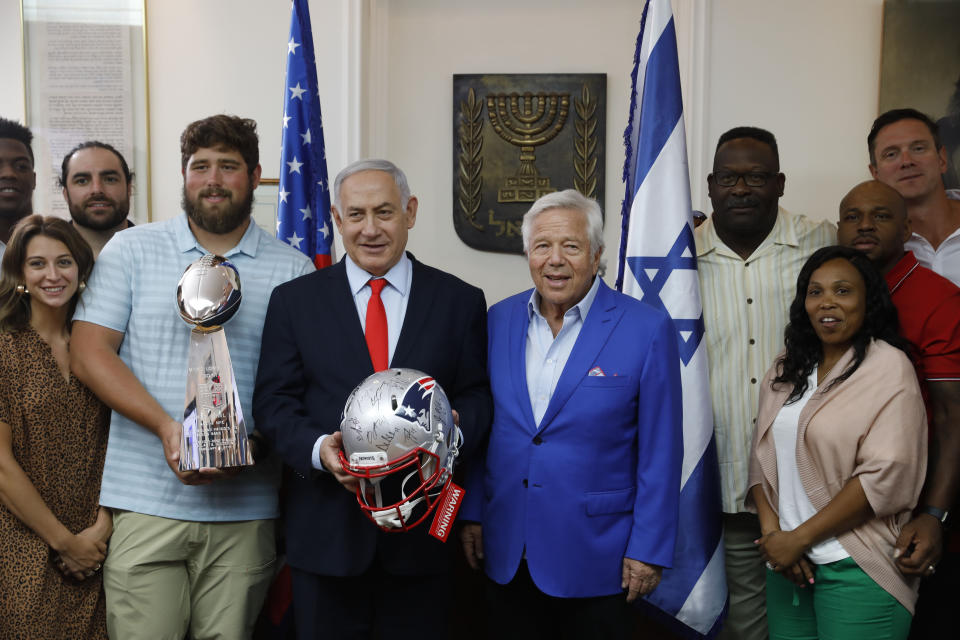 Israel's Prime Minister Benjamin Netanyahu, center left, and the New England Patriots owner Robert Kraft, venter right, pose for a photo in Jerusalem, Thursday, June 20, 2019. Israel will honor Kraft with the 2019 Genesis Prize for his philanthropy and commitment to combatting anti-Semitism. (AP Photo/Sebastian Scheiner)