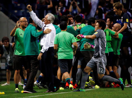 Football Soccer - Japan v Iraq - World Cup 2018 Qualifier - Saitama Stadium 2002, Saitama, Japan - 6/10/16. Japan's head coach Vahid Halilhodzic (L) celebrates with his team members after Japan's Hotaru Yamaguchi scored the second goal for Japan against Iraq. REUTERS/Issei Kato