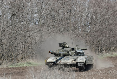 FILE PHOTO: A Ukrainian tank drives in Donetsk Region, Ukraine April 9, 2019. Picture taken April 9, 2019. REUTERS/Gleb Garanich/File Photo