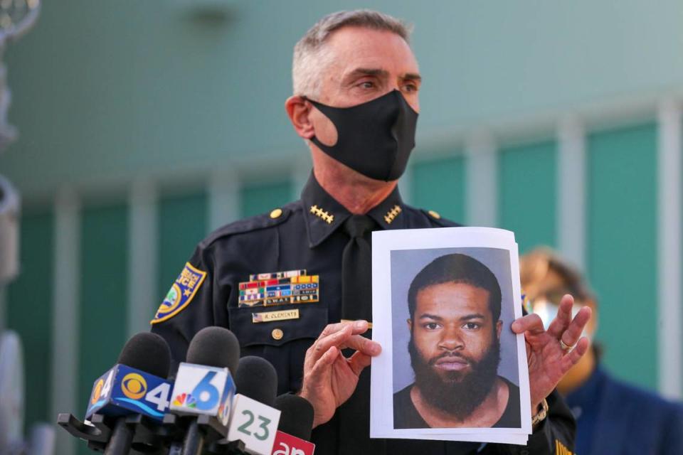 Miami Beach Police Department Chief Richard Clements holds a picture of a suspect during a press conference at the Miami Beach Police Headquarters following a violent weekend in South Beach that included an armed robbery of a tourist and a triple shooting outside a restaurant, Monday, February 1, 2021.