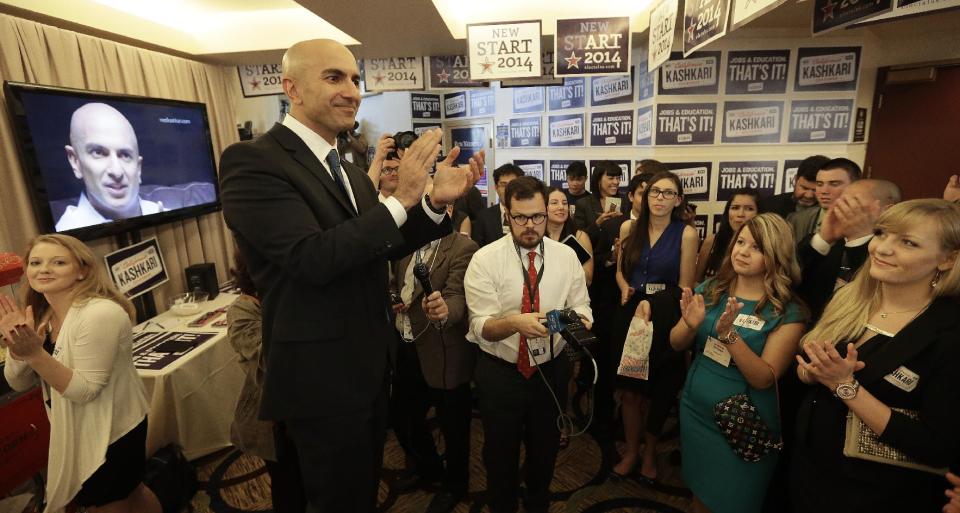 Gubernatorial candidate Neel Kashkari speaks with his campaign workers at the California Republican Party 2014 Spring Convention Saturday, March 14, 2014, in Burlingame, Calif. (AP Photo/Ben Margot)