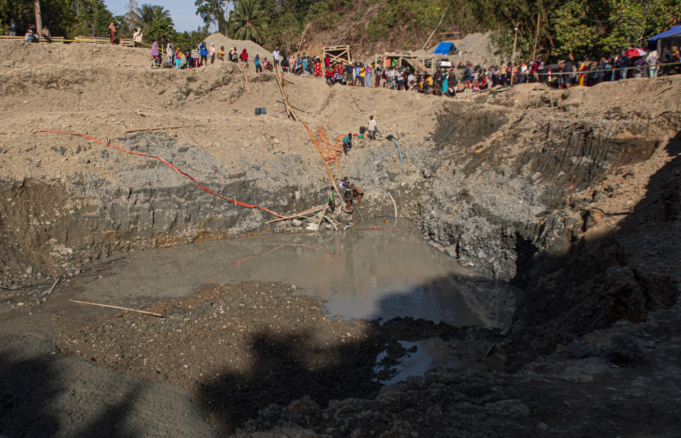Rescuers search for victims at a collapsed gold mine in Parigi Moutong, Central Sulawesi, Indonesia, Thursday, Feb. 25, 2021. The illegal gold mine in Central Indonesia collapsed on miners working inside, leaving a number of people killed, officials said Thursday. (AP Photo/M. Taufan)