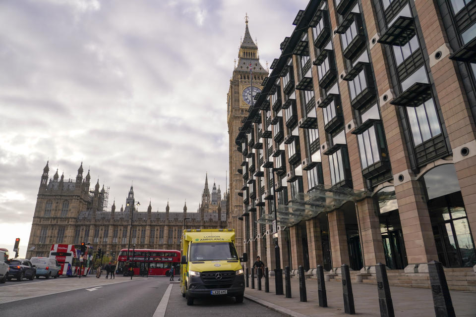 An ambulance is parked outside Portcullis House, backdropped by the Elizabeth Tower, commonly known as Big Ben, in London, Thursday, Dec. 1, 2022. Some 10000 ambulance staff have voted to strike over pay and working conditions, along with a possible 100,000 nurses going on strike on Dec1. 5, leading the Government to set up contingency plans to cope with a wave of walkouts with Cabinet Minister Oliver Dowden in charge. (AP Photo/Alberto Pezzali)