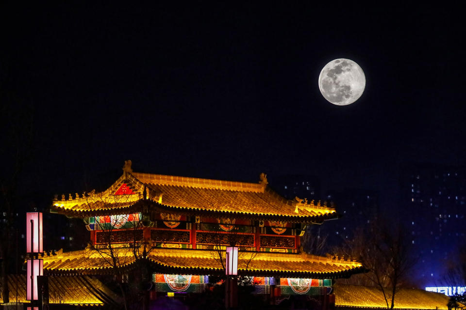 A full moon rises above an ancient building during the Lantern Festival in Taian in Shandong province of China, on Feb. 5, 2023.