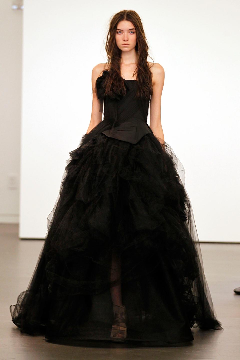 A model walks in a black wedding dress.