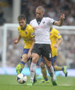 Arsenal's Aron Ramsey gets tackled by Fulham Pajtim Kasami during the Barclays Premier League match at Craven Cottage, London.