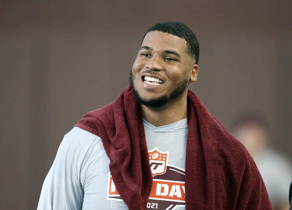 FILE - Christian Darrisaw smiles after completing a set of offensive line drills during Virginia Tech Pro Day in Blacksburg, Va., in this Friday, March 26, 2021, file photo. Darrisaw is a possible first round pick in the NFL Draft, April 29-May 1, 2021, in Cleveland. (AP Photo/Matt Gentry, File)