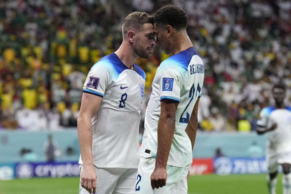 England's Jordan Henderson, left, celebrates with his teammate Jude Bellingham after scoring his side's first goal during the World Cup round of 16 soccer match between England and Senegal, at the Al Bayt Stadium in Al Khor, Qatar, Sunday, Dec. 4, 2022. (AP Photo/Hassan Ammar)
