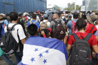 Migrants attempt to cross the border from Corinto, Honduras, into Corinto, Guatemala, Thursday, Oct. 1, 2020. Hundreds of migrants walked from San Pedro Sula, Honduras to the Guatemala border, testing a well-trod migration route now in times of the new coronavirus. (AP Photo)