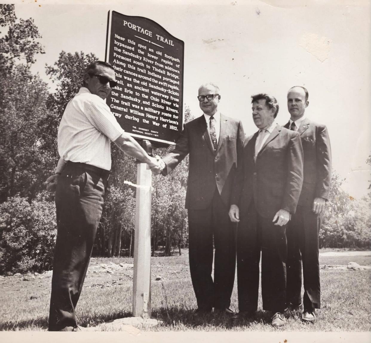 This photo shows the original portage marker dedication in 1971.