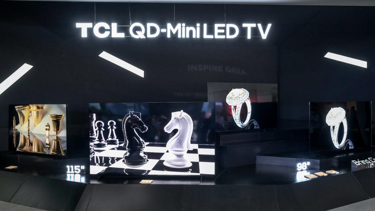  TCL X955 in two sizes on display on black stand  