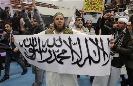 A protester holds up a sign during a rally calling for the boycott of the Algerian presidential election in Algiers March 21, 2014. REUTERS/Louafi Larbi