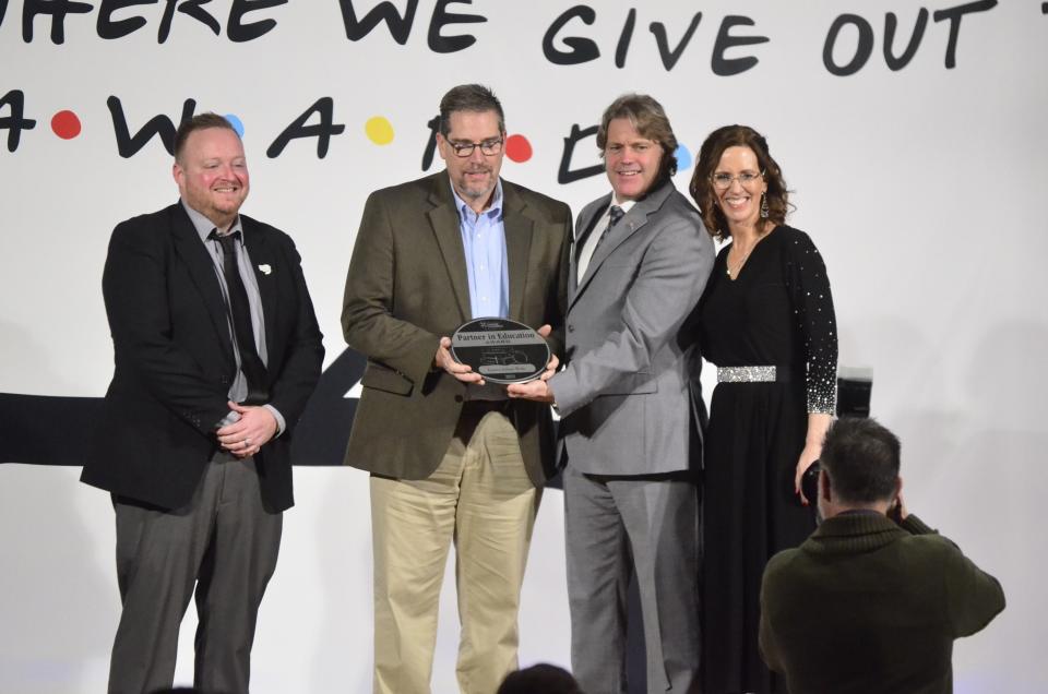 Wayne Williams and Gus Linde from Eastern Indiana Works receive the Partnership in Education award from 2024 Chamber Board Chair Ron Holbrook and Chamber President and CEO Melissa Vance during the 2024 Wayne County Area Chamber of Commerce Annual Dinner at First Bank Kuhlman Center, Friday, Jan. 19, 2024.