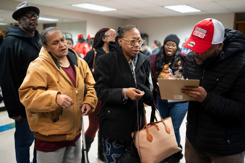 Cynthia Wray, center, waits to get her name on a list for relocation with Section 8 housing, during a community meeting held by the city to discuss the relocation of everyone at Colonial Village. Wray and all 508 units have been told they have to leave by Dec. 31.