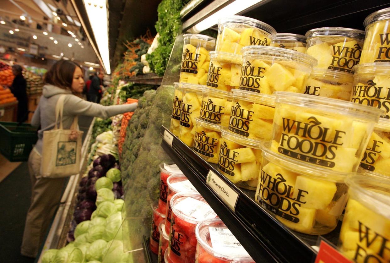 whole foods to buy wild oats markets for $565 million