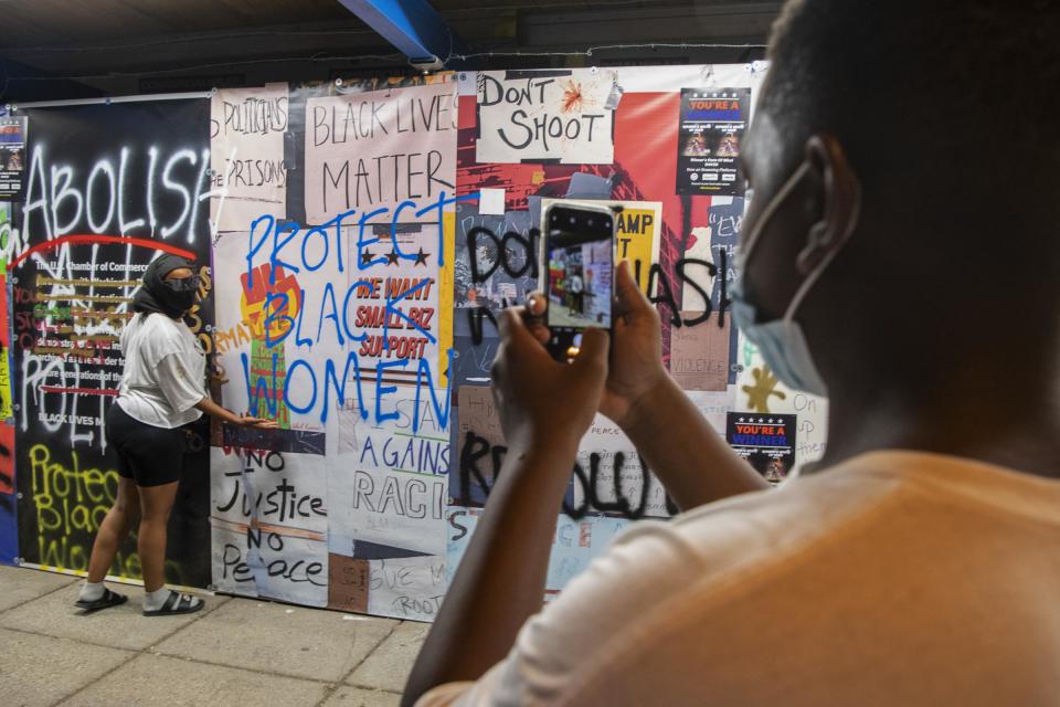 Heather Johnson has her picture taken by her 13-year-old son, Elyjah, after attending protests outside the White House at the end of the Republic National Convention on Aug. 27, 2020, the night before attending the "Get Your Knee Off Our Necks" March in Washington D.C. on the anniversary of the 1963 March on Washington.