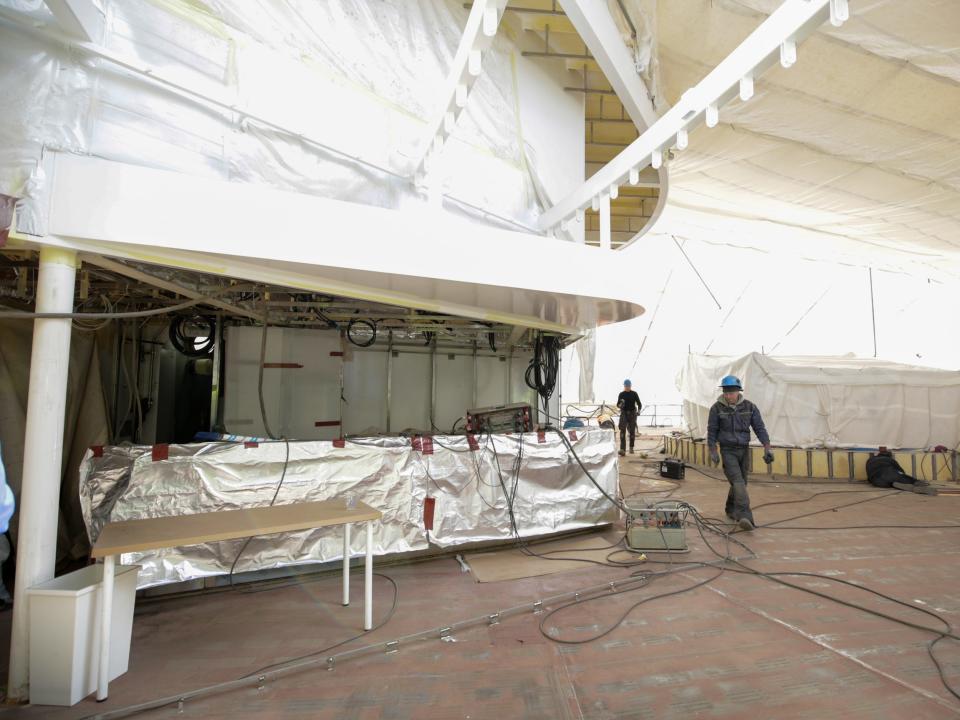 An indoor-outdoor space under construction with scaffolding on Royal Caribbean's Icon of the Seas