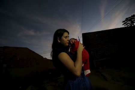 Ianka Mikaelle Barbosa, 18, poses for a photograph with Sophia, 18 days old, who is her second child and was born with microcephaly, at her house in Campina Grande, Brazil February 17, 2016. REUTERS/Ricardo Moraes