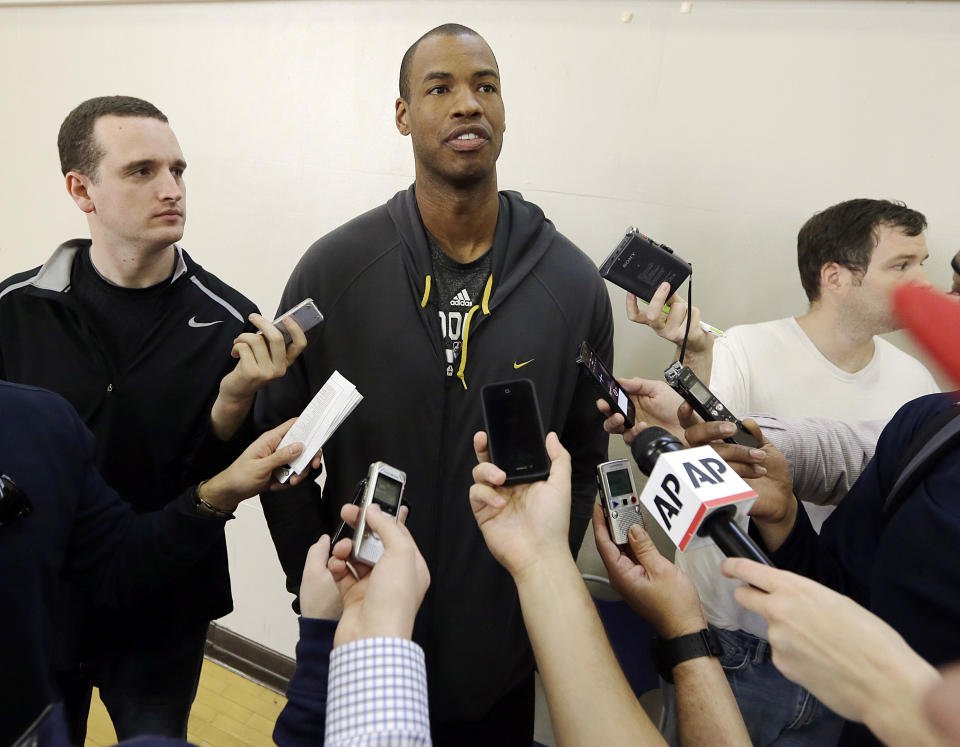 Brooklyn Nets center Jason Collins talks with reporters during practice on the campus of UCLA in Los Angeles Tuesday, Feb. 25, 2014. Collins became the first openly gay active athlete in North America's four major professional sports Sunday, Feb. 23, signing a 10-day contract with the Brooklyn Nets. (AP Photo/Reed Saxon)