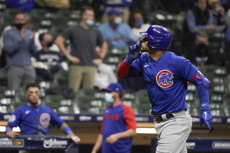 Chicago Cubs' Willson Contreras gestures to the crowd after hitting a two-run home run during the eighth inning of a baseball game against the Milwaukee Brewers Tuesday, April 13, 2021, in Milwaukee. (AP Photo/Morry Gash)