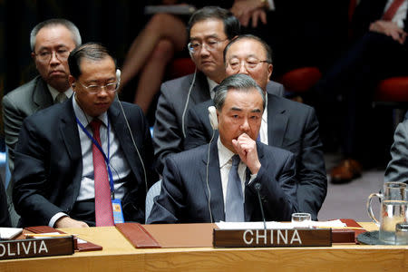 China's Foreign Minister Wang Yi and the Chinese delegation listen to U.S. President Donald Trump address the U.N. Security Council meeting at the 73rd session of the United Nations General Assembly at U.N. headquarters in New York, U.S., September 26, 2018. REUTERS/Carlos Barria