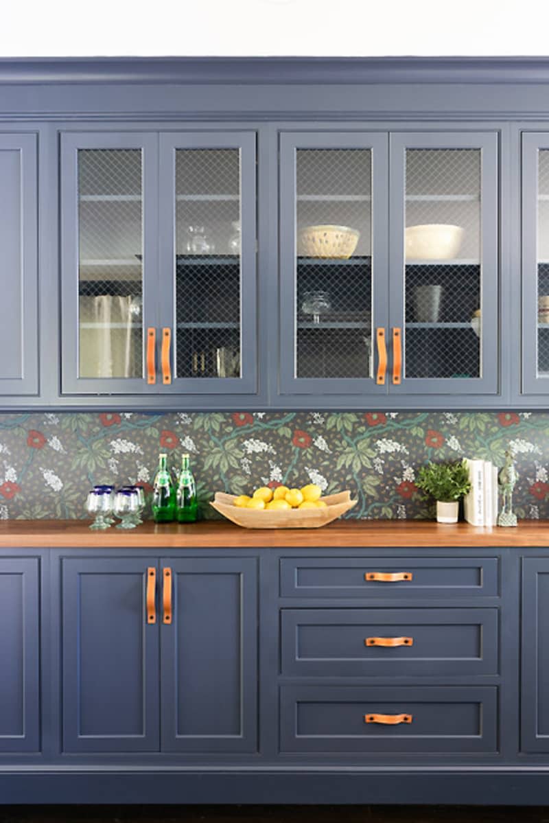 Dark blue cabinets with copper handles.