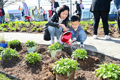 Attendees plant native species at the new pollinator garden at Life's Good Earth Day Community Fair, Monday, April 22, 2024, at the LG Electronics North American Innovation Campus in Englewood Cliffs, NJ.  Earning a Certified Wildlife Habitat® certification through the NWF, LG's garden is outfitted with native plants, designed to attract a mixture of pollinators, such as bees, butterflies, moths, and beetles, which will encourage biodiversity, plant growth, clean air, and support wildlife.  (Diane Bondareff/AP Images for LG Electronics)