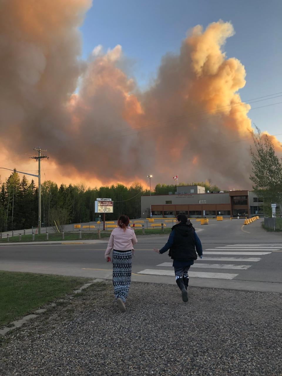 Smoke from the Parker Creek wildfire rises over Fort Nelson Secondary School Friday, May 10, 2024, shortly before the community was ordered to evacuate.