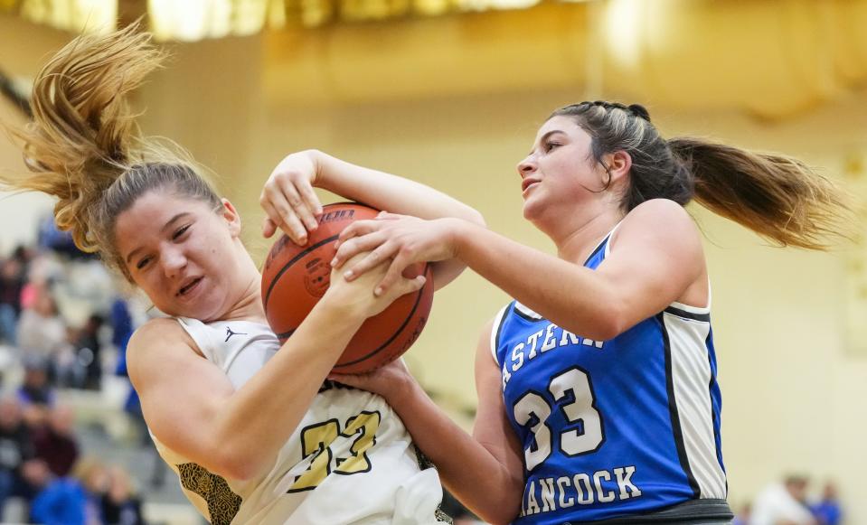 Lapel Bulldogs Annalee Stow (33) reaches for the ball against Eastern Hancock guard Makenzie O'Neal (33) on Tuesday, Dec. 12, 2023, during the game at Lapel High School in Lapel. Eastern Hancock defeated the Lapel Bulldogs, 62-55.