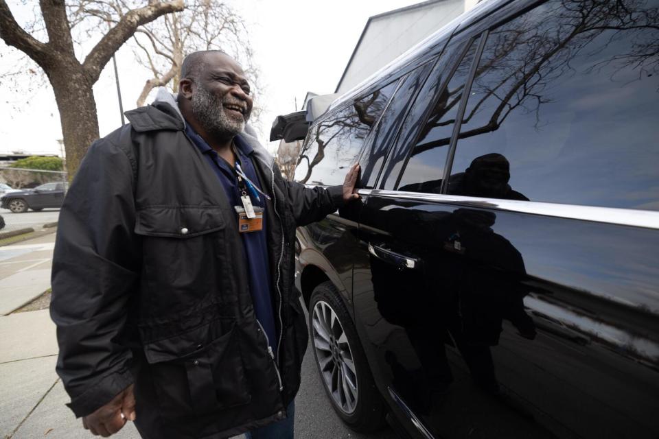 Lee Reed pauses outside a vehicle.