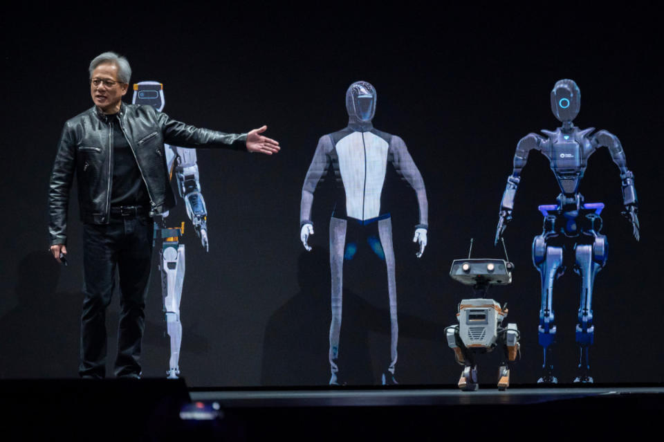 Jensen Huang, Nvidia's co-founder and CEO, shows off robots the company helped develop at a developer conference last winter.<p>Bloomberg/Getty Images</p>