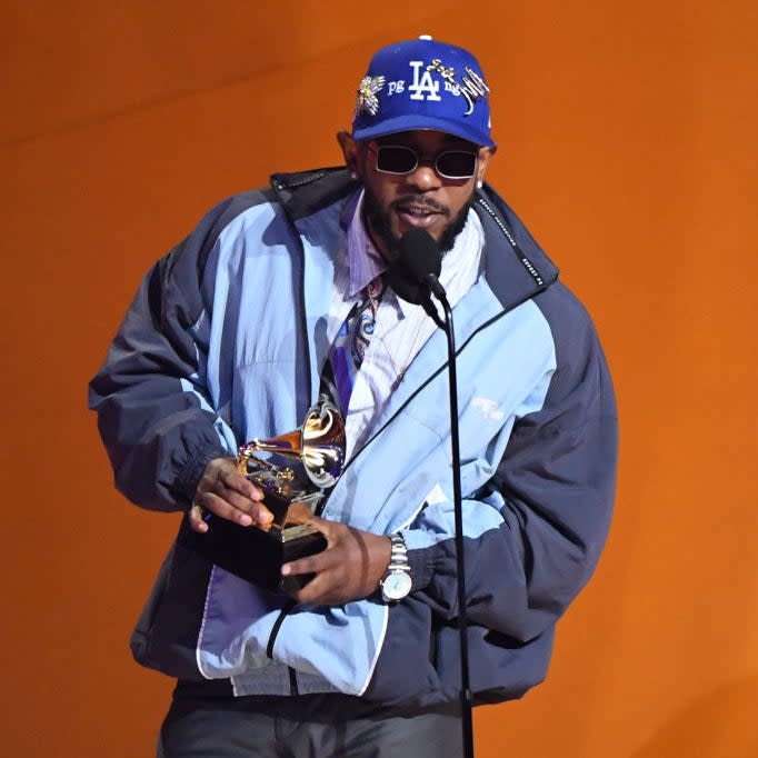 Kendrick Lamar accepting a Grammy onstage