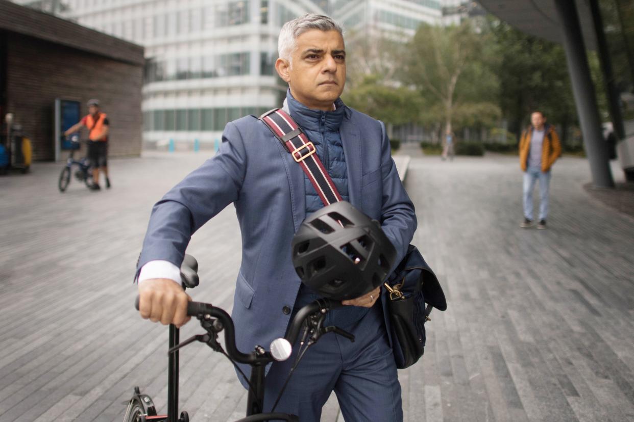 <p>Es are good: Mayor Sadiq Khan with his electric-powered bike</p> (PA)