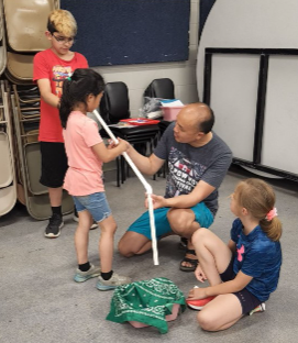 Volunteer mentor Howard Chong is shown here working with children involved in a Boys & Girls Clubs of Topeka program that teaches youngsters about "STEM," which is science, technology, engineering and mathematics.