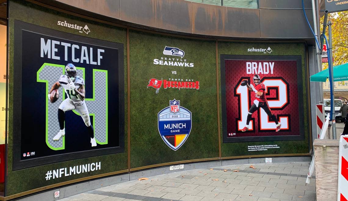 Seahawks wide receiver DK Metcalf shares top billing with Tampa Bay Buccaneers legendary quarterback Tom Brady, 21 years his senior, on this display in the Marienplatz section of Munich for Sunday’s first NFL regular-season game in Germany.