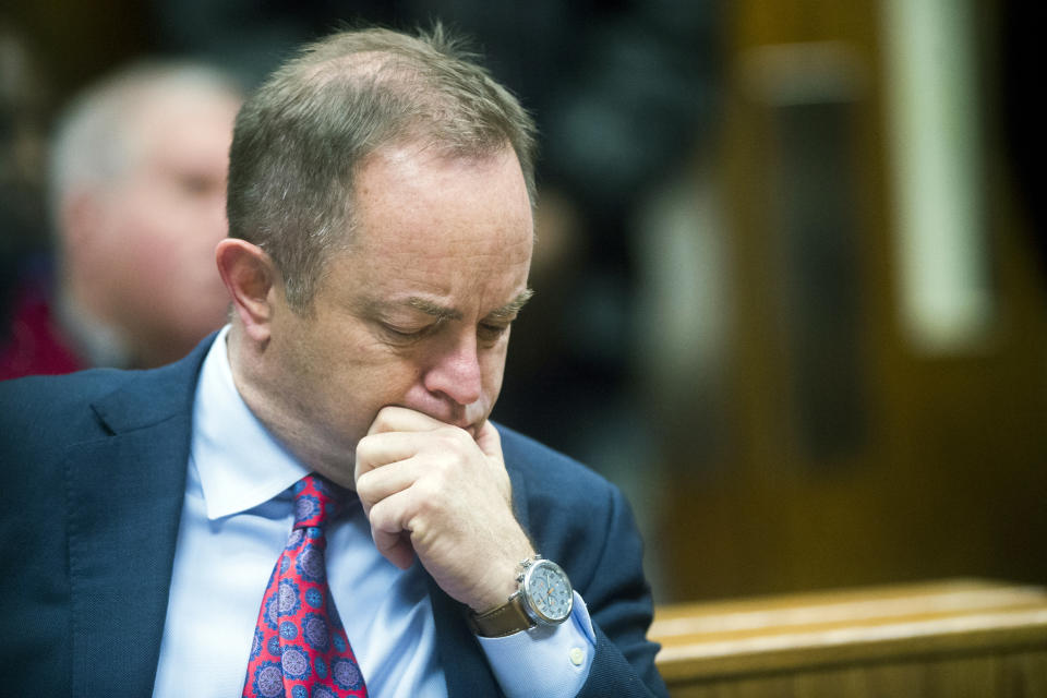 Special Prosecutor Todd Flood listens as Genesee District Judge William Crawford reads through a prepared statement during a hearing Friday, Dec. 7, 2018, at Genesee District Court in downtown Flint, Mich. Dr. Eden Wells, Michigan's chief medical executive, will stand trial on involuntary manslaughter and other charges in a criminal investigation of the Flint water crisis, Crawford ruled Friday. (Jake May/The Flint Journal via AP)