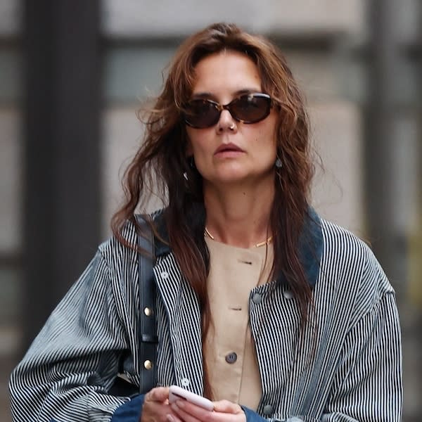  Katie Holmes wearing a navy-and-white barn jacket with camel Lafayette 148 vest and white trousers in New York City May 2024. 
