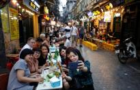 Beer drinkers take a selfie at a restaurant in the Old Quarter in Hanoi