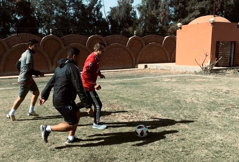 FILE PHOTO: Ezzeldin Bahader, a 75-year-old Egyptian football player, kicks the ball during his taining in Cairo