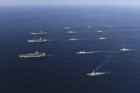 FILE - In this Nov. 12, 2017, file photo provided by South Korea Defense Ministry, three U.S. aircraft carriers USS Nimitz, left top, USS Ronald Reagan, left center, and USS Theodore Roosevelt, left bottom, participate with other U.S. and South Korean navy ships during the joint naval exercises between the United States and South Korea in waters off South Korea's eastern coast in South Korea. Ahead of the second summit between U.S. President Donald Trump and North Korean leader Kim Jong Un, some observers say there is an uncertainty over the future of the decades-long military alliance between Washington and Seoul. (South Korea Defense Ministry via AP, File)