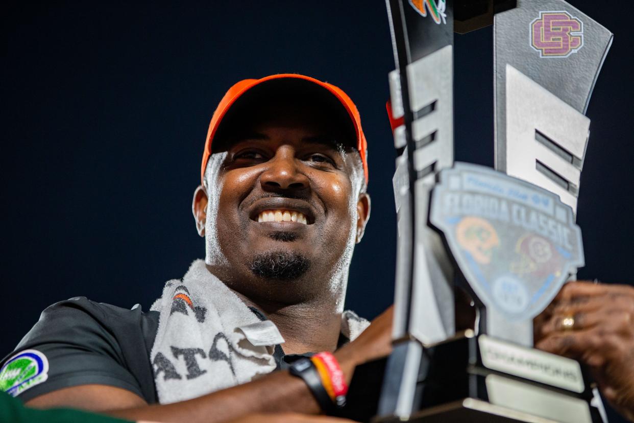 Florida A&M Rattlers head coach Willie Simmons holds up the trophy after he and his team defeated the BCU Wildcats 41-20 during the annual Florida Classic at Camping World Stadium on Saturday, Nov. 19, 2022.